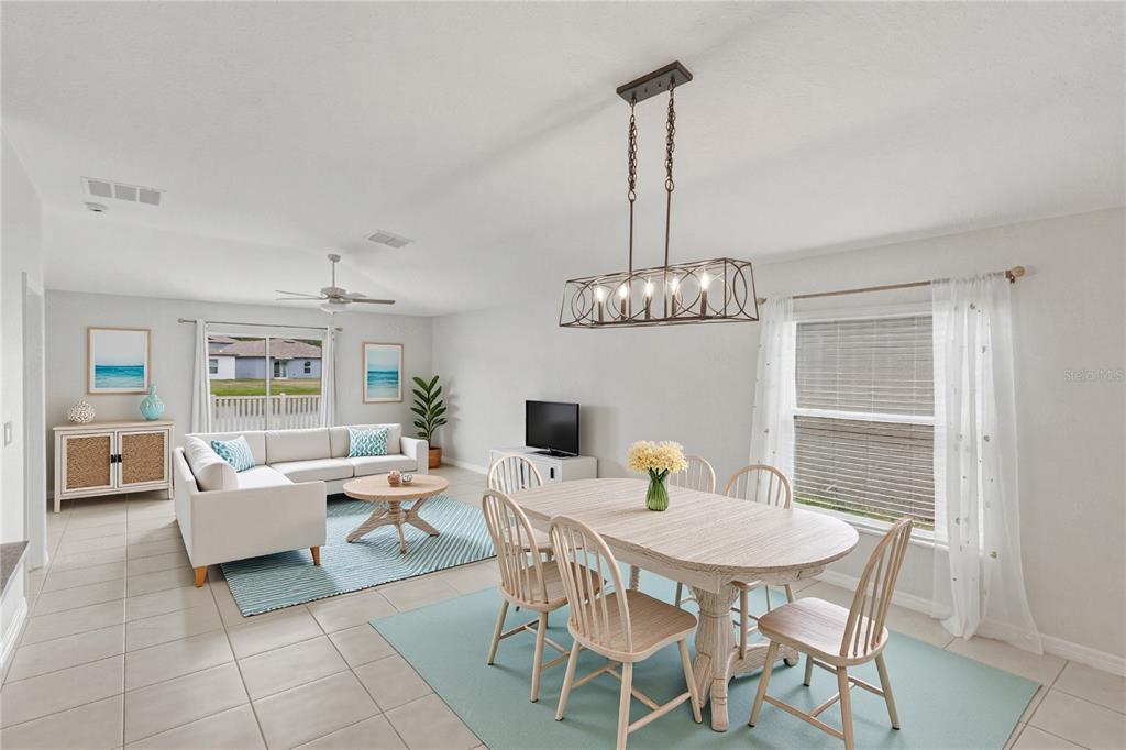 An entryway with tile flooring, a white front door, and a doorway to a laundry room — 4334 TROTTERS WAY, LAKELAND, FL