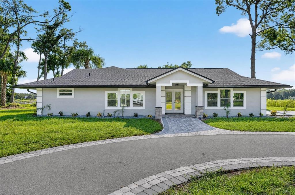 A single-story house with a gray exterior, a paved walkway, and a circular driveway — 401 N 1ST STREET, LAKE MARY, FL