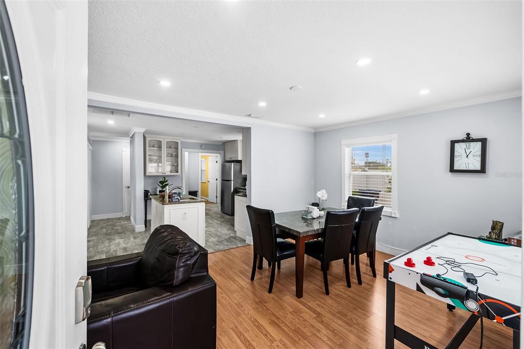 A dining area with a table and chairs sits adjacent to an open kitchen — 8912 N 40TH STREET, TAMPA, FL