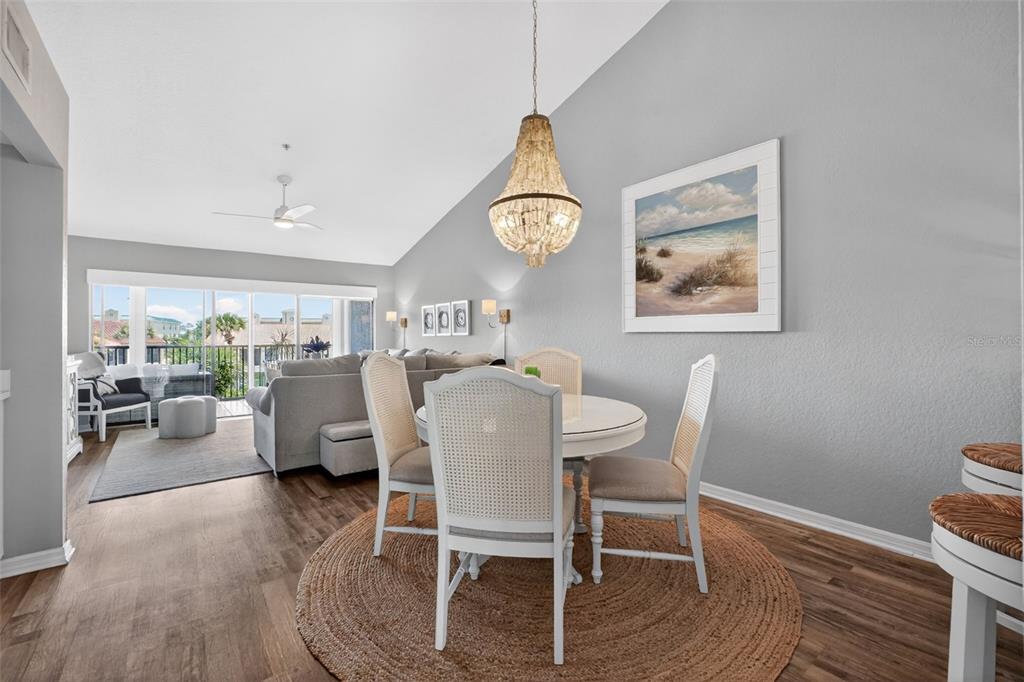 A living room features a large sectional sofa, a ceiling fan, and a balcony view — 443 BOUCHELLE DRIVE UNIT 302, NEW SMYRNA BEACH, FL