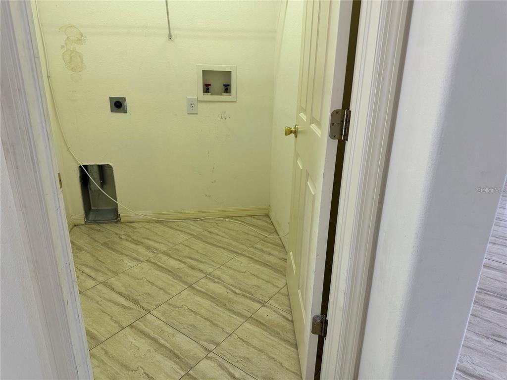 A laundry closet features tile flooring, a washer hookup box, and a dryer vent opening — 903 COADE STONE DRIVE, SEFFNER, FL