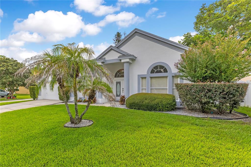 A single-story house with a white stucco exterior, a two-car garage, and a concrete driveway — 514 KEY COURT, ORLANDO, FL