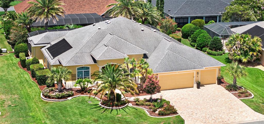 An aerial view of a single-story suburban house with a gray roof and tan exterior — 622 LAUREL RUN, THE VILLAGES, FL