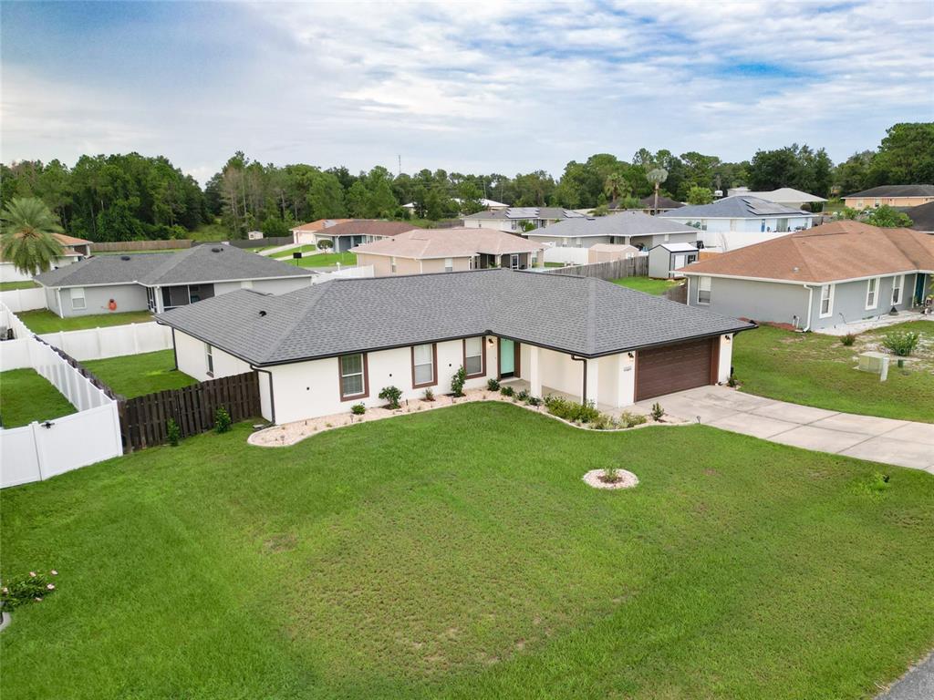 An aerial view of a single-story house with a gray roof and white exterior — 10143 SE 122ND LANE, BELLEVIEW, FL