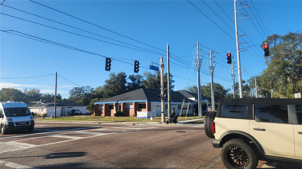 A street-level view of a commercial building at an intersection with traffic lights — DRUID ROAD E, CLEARWATER, FL