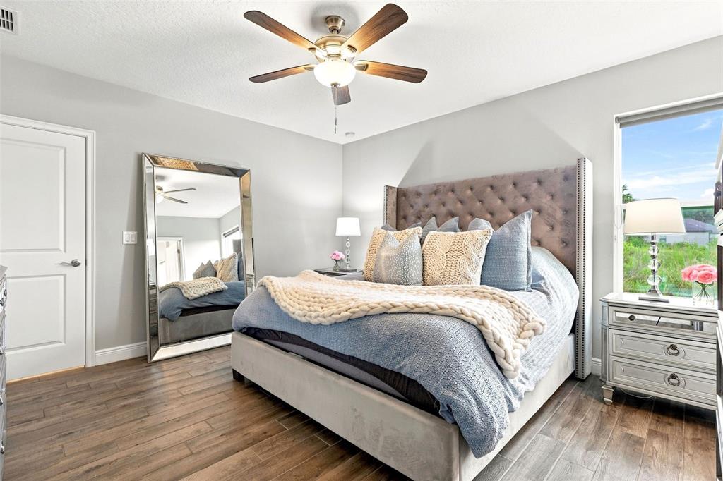A living room features light-colored leather furniture, a glass coffee table, and a ceiling fan — 520 S SHELL ROAD, DELAND, FL