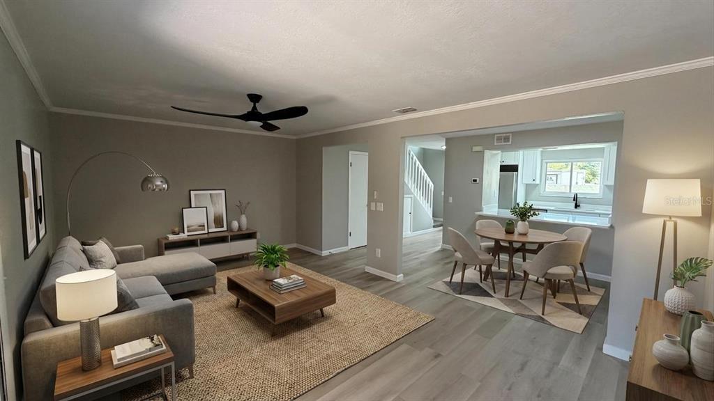 A living room and dining area with light wood flooring, gray walls, and modern furniture — 434 SAND LIME ROAD, WINTER GARDEN, FL