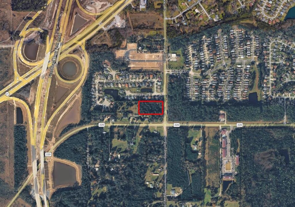 An aerial map view showing a rectangular property lot outlined in red near a highway — BAXLEY ROAD, MIDDLEBURG, FL