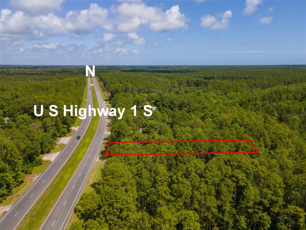 An aerial view shows a rectangular plot of land outlined in red beside a highway — 9152 U S HIGHWAY 1, ST AUGUSTINE, FL