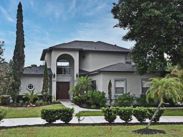 A two-story house with a gray stucco exterior, a dark roof, and a front walkway — 11994 MCKINNON ROAD, WINDERMERE, FL