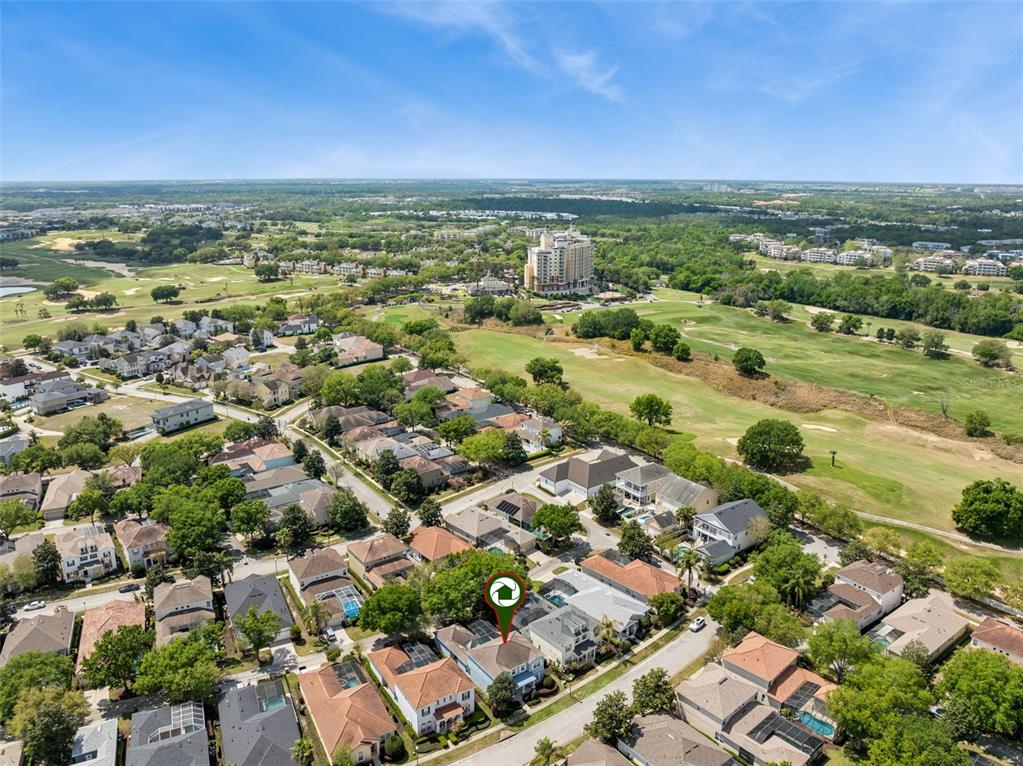 An aerial view shows a residential neighborhood with houses, a golf course, and a large hotel — 7412 DEVEREAUX STREET, REUNION, FL