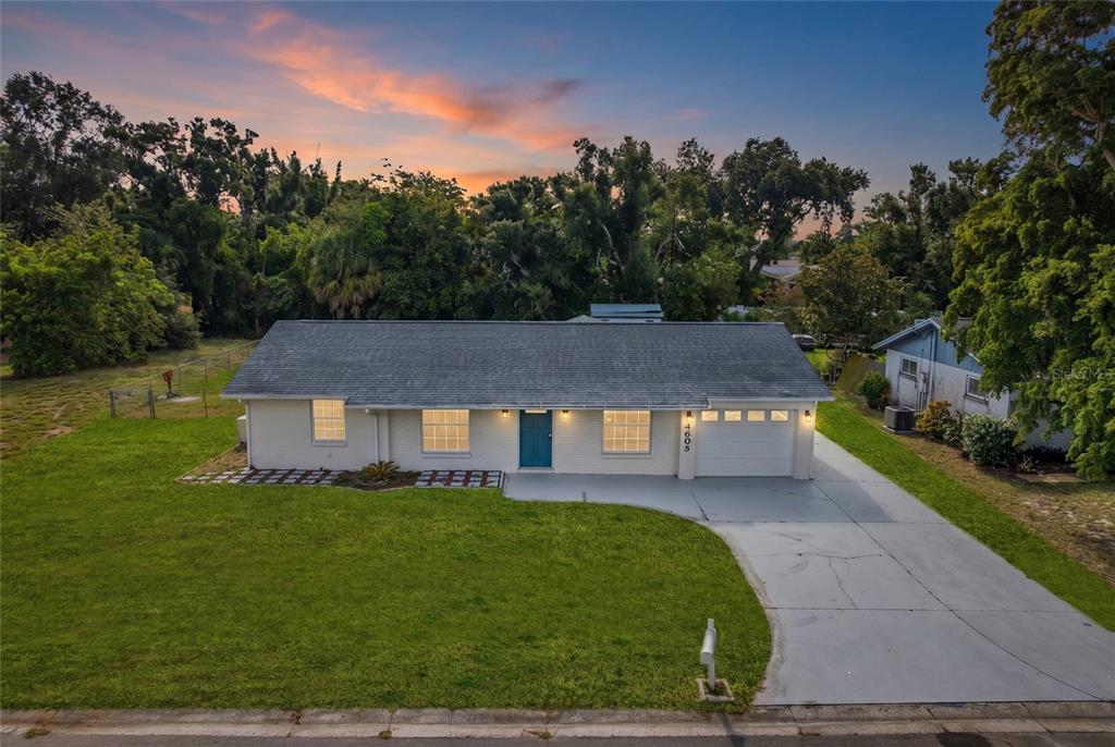 An aerial view of a single-story house with a gray roof, white brick, and driveway — 4603 ATLANTIC AVENUE, SARASOTA, FL