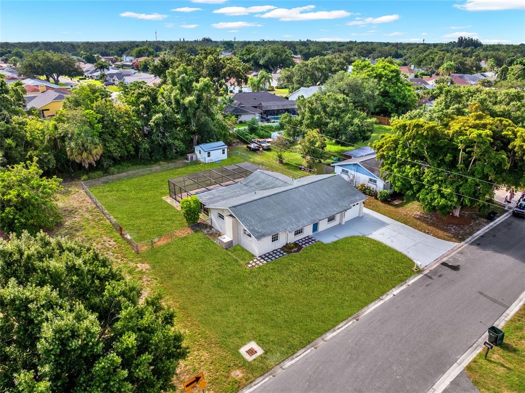 An aerial view shows a single-story house with a screened pool and a large yard — 4603 ATLANTIC AVENUE, SARASOTA, FL