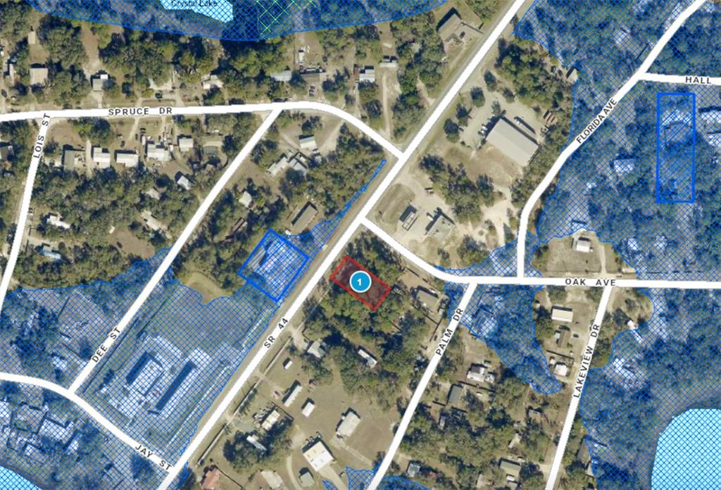 This is an aerial map showing a highlighted property lot located near SR 44 — LOT 13 STATE ROAD 44, EUSTIS, FL