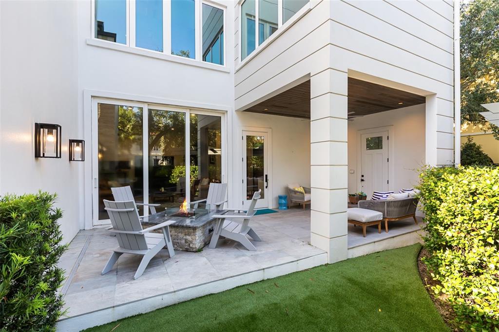 The exterior of a modern home features a brick facade, white door, and manicured hedges — 660 W MORSE BOULEVARD, WINTER PARK, FL