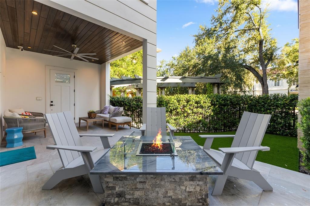 A living room with leather sofas opens through sliding glass doors to a patio with chairs — 660 W MORSE BOULEVARD, WINTER PARK, FL