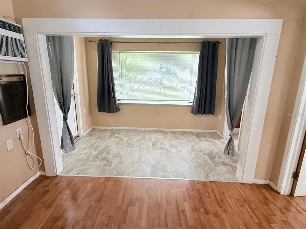 A kitchen features wood cabinets, a breakfast bar, and a door leading to the outdoors — 1661 27TH AVENUE N, ST PETERSBURG, FL
