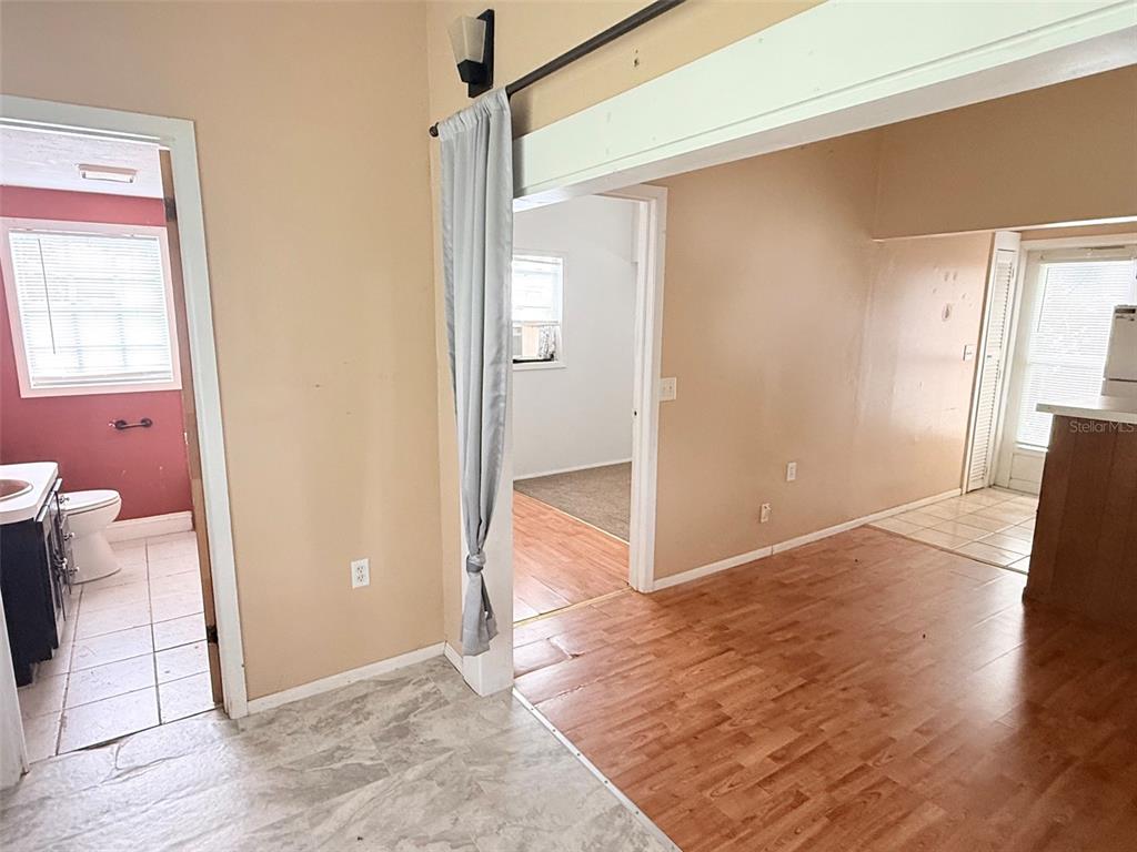 A kitchen features a white refrigerator, a double-basin sink, wooden cabinets, and a white stove — 1661 27TH AVENUE N, ST PETERSBURG, FL
