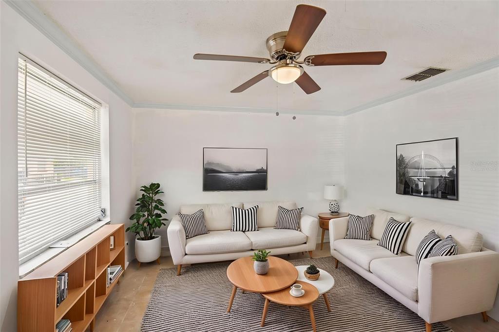 A bathroom features a white vanity, a toilet, and a walk-in shower with white walls — 4923 GETNER STREET, NEW PORT RICHEY, FL