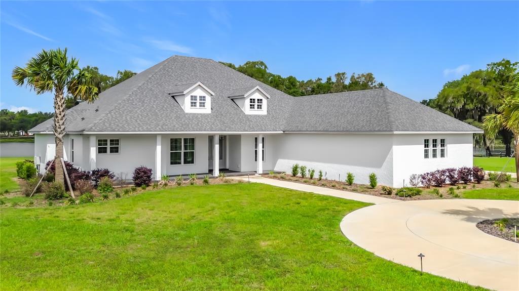 An aerial view of a long, white, multi-winged building with three turrets and dark roofing — 6530 SE 156TH LOOP UNIT 3 & 4, SUMMERFIELD, FL