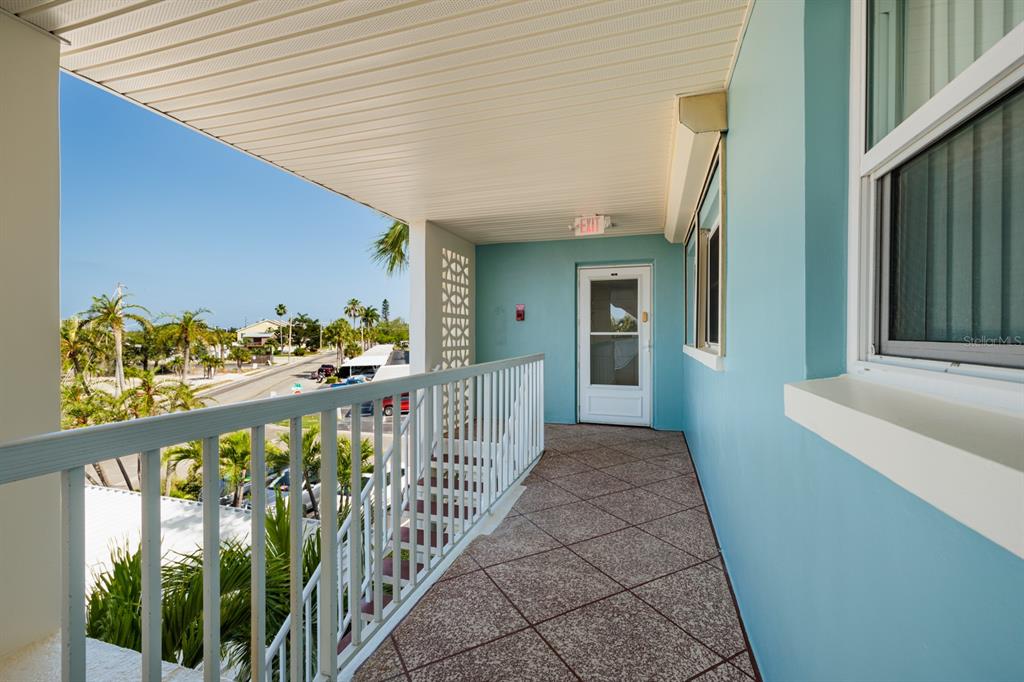 An aerial view of a sandy beach lined with hotels and condominiums along the coast — 6161 GULF WINDS DRIVE UNIT 338, ST PETE BEACH, FL