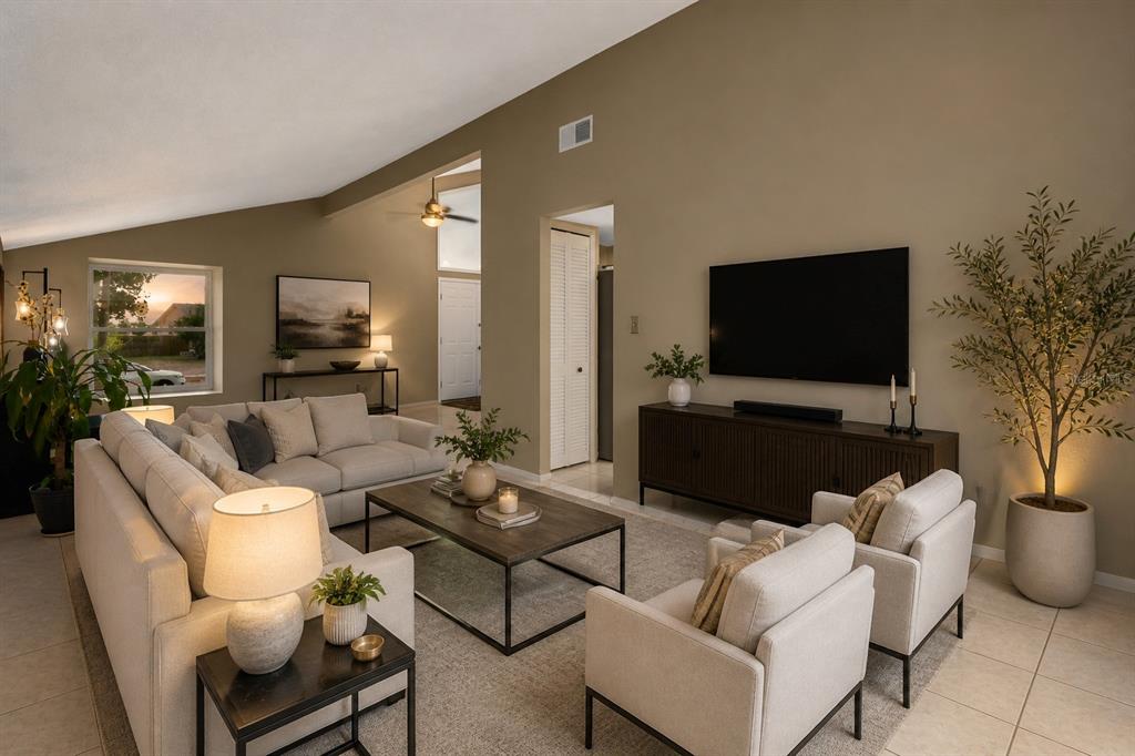A two-story house with a white stucco exterior, black garage door, and a concrete driveway — 1304 ORTEGA STREET, WINTER SPRINGS, FL