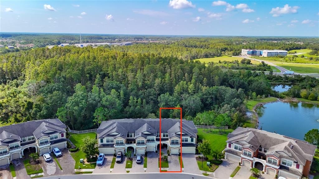 An aerial view shows a row of townhouses with a red outline highlighting one specific unit — 30305 SOUTHWELL LANE, WESLEY CHAPEL, FL