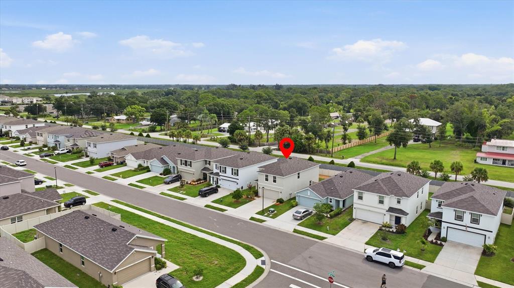 An aerial view shows a suburban neighborhood with houses, driveways, and a red location marker — 3015 GREAT ABACO WAY, BRADENTON, FL