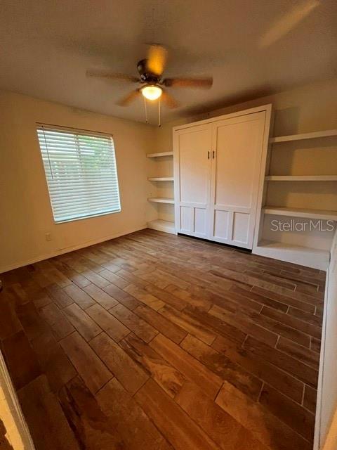 A room with wood-look tile flooring, a ceiling fan, a window, and a white wall unit — 3444 GELDING COURT, PORT ORANGE, FL