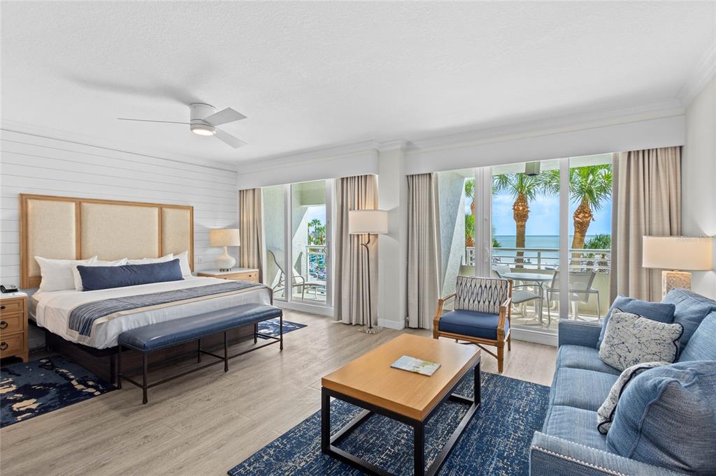 A hotel room features a king bed, a sitting area, and a balcony overlooking the ocean — 230 SANDS POINT ROAD UNIT 3205, LONGBOAT KEY, FL