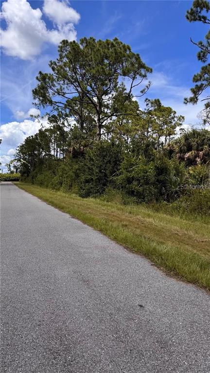 This aerial map view shows a wooded, undeveloped residential lot surrounded by neighboring houses — 72 POMPANO STREET, PORT CHARLOTTE, FL