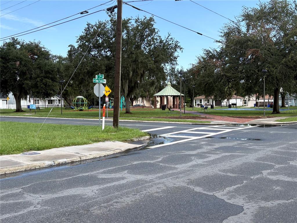A street corner view shows a public park with a gazebo, playground, and crosswalk — 1233 N NEW YORK AVENUE, LAKELAND, FL