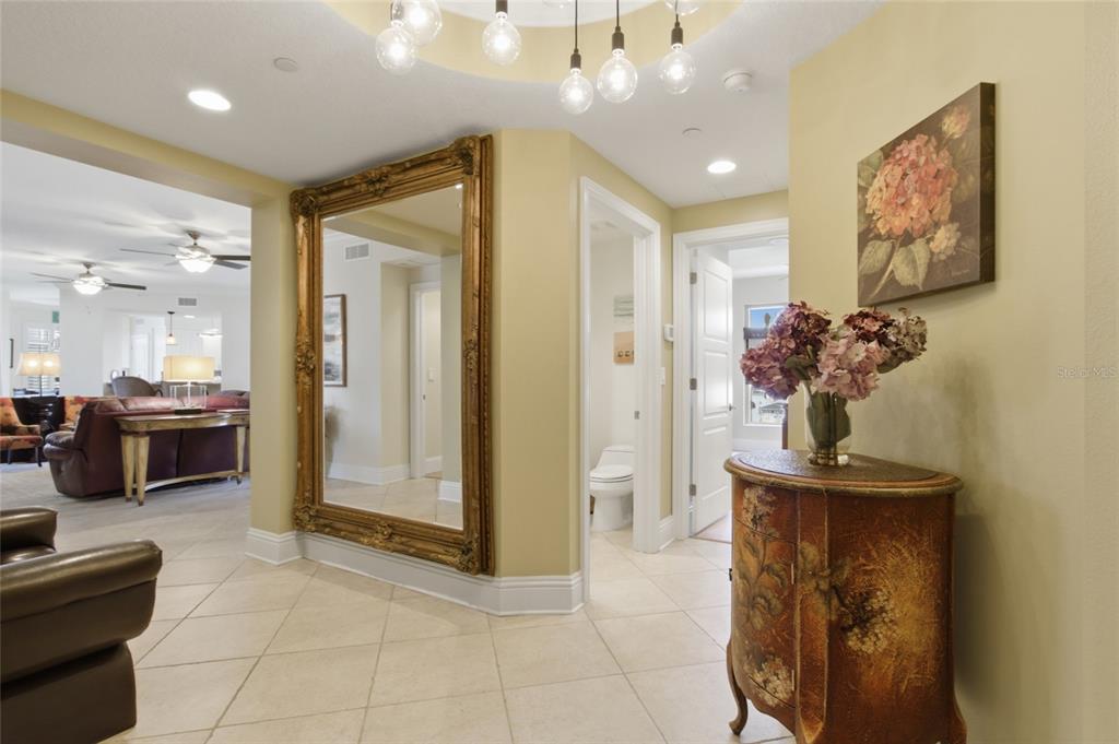 An open-concept living and dining area features tile flooring, ceiling fans, and neutral walls — 11 BAYMONT STREET UNIT 608, CLEARWATER BEACH, FL
