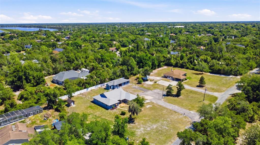 A single-story gray brick house with a hip roof and a concrete walkway — 168 COMMUNITY DRIVE, DEBARY, FL