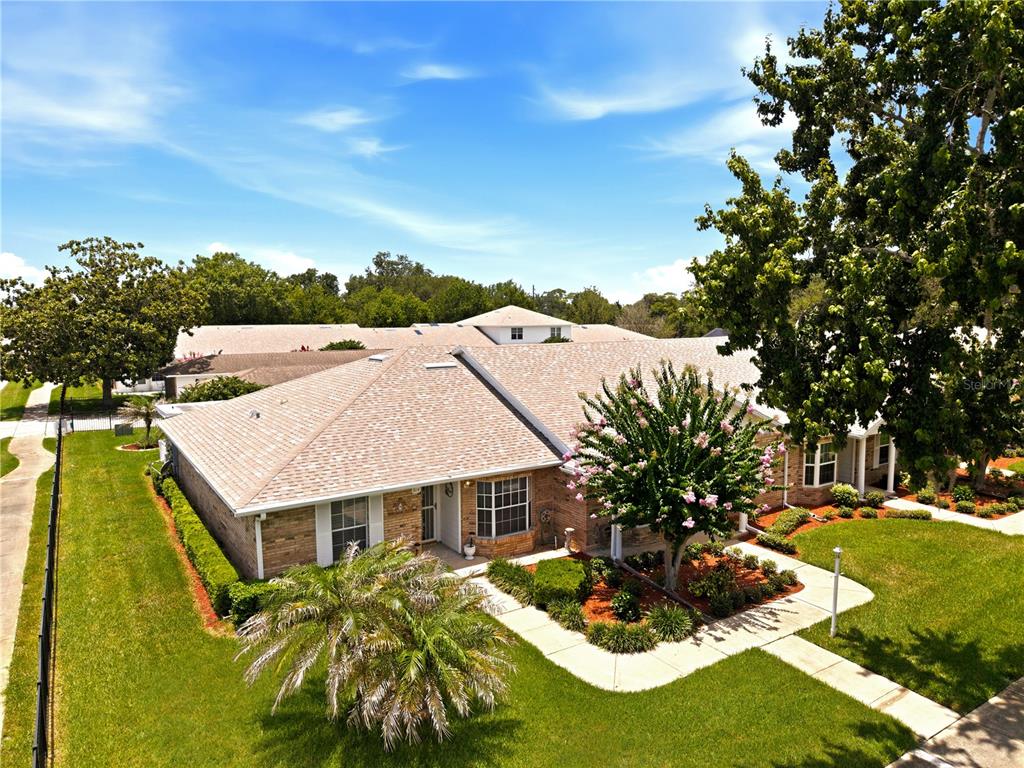 A single-story brick house with a front lawn, sidewalk, and a large tree — 914 MICHIGAN AVENUE, ST CLOUD, FL