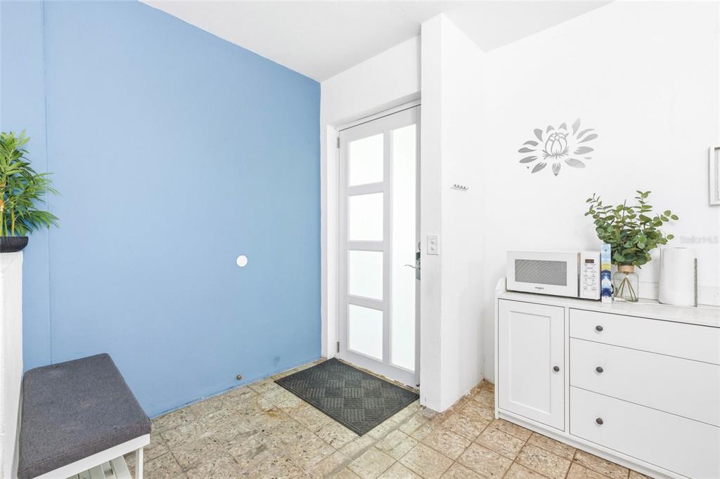 An entryway features a blue accent wall, a white cabinet, and a glass-paneled door — 10 CALLE COVALLE GANDIA STREET UNIT 201 B, ARECIBO, PR
