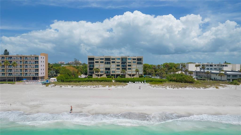 An aerial view of a white sand beach with high-rise condominiums along the coastline — 2675 GULF OF MEXICO DRIVE UNIT 204, LONGBOAT KEY, FL