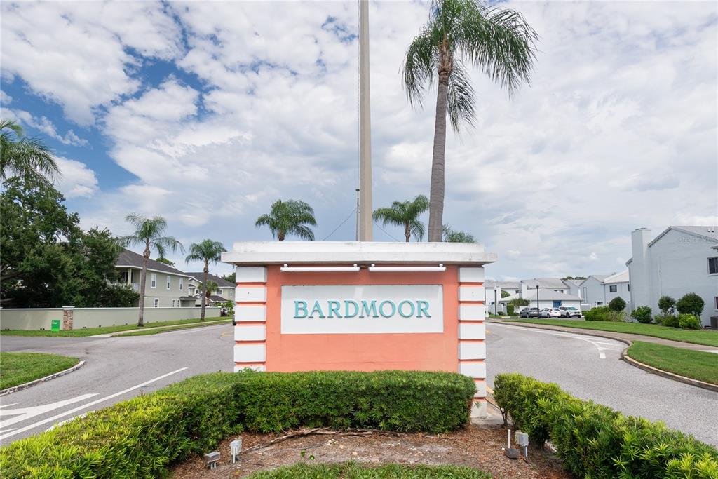 A salmon-colored monument sign with the name Bardmoor stands at a residential community entrance — 209 CORDOVA GREEN UNIT 209, SEMINOLE, FL