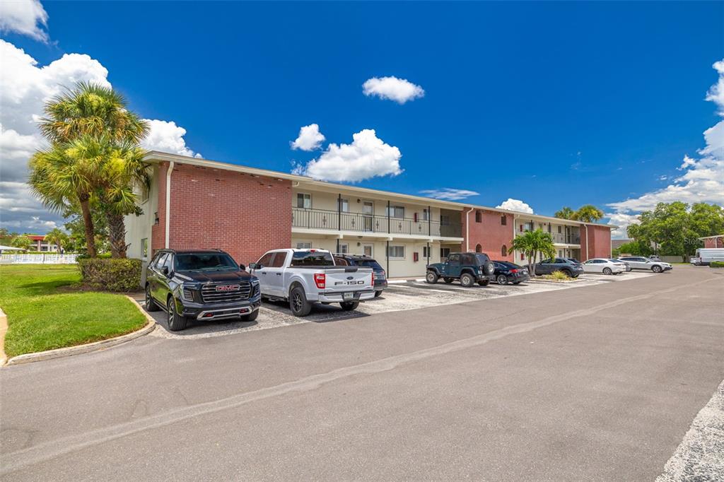 A two-story apartment building with a brick facade and a parking lot in front — 4550 OVERLOOK DRIVE NE UNIT 152, ST PETERSBURG, FL
