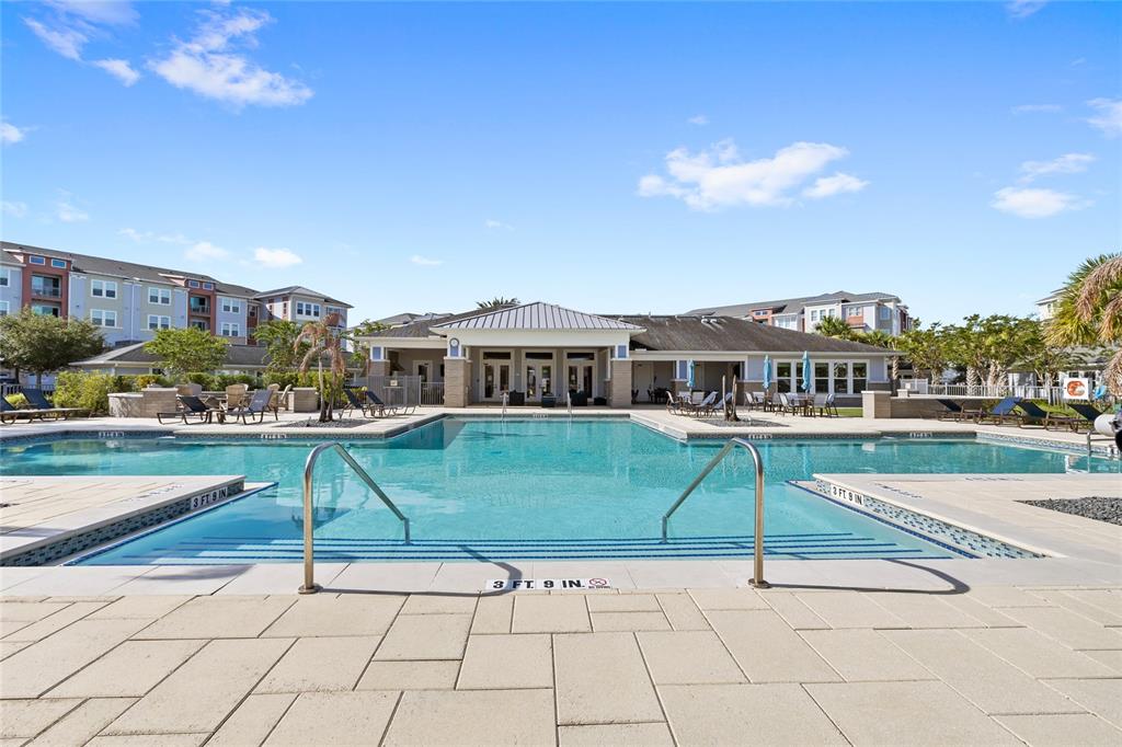 An aerial view shows an apartment complex with a swimming pool, tennis court, and parking — 7505 LAUREATE BOULEVARD UNIT 2206, ORLANDO, FL