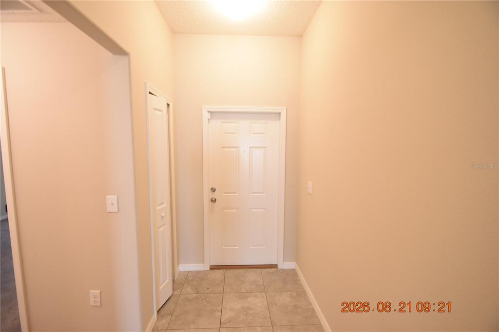 An entryway features a white front door, tiled flooring, and a small closet — 8436 HUNTERS FORK LOOP, RUSKIN, FL