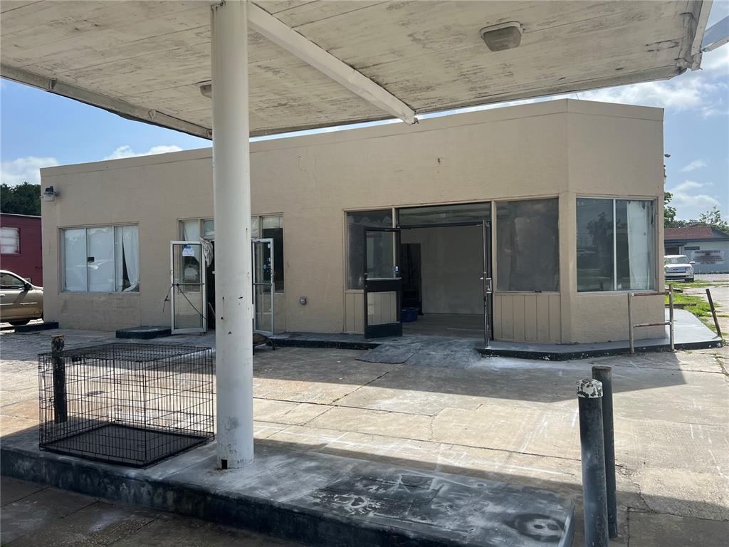 An exterior view of a vacant, single-story commercial building with a covered fuel pump canopy — 100 PONCE DE LEON BOULEVARD, BROOKSVILLE, FL