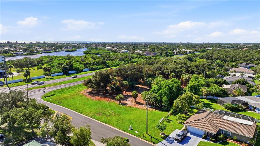 An aerial view shows a vacant rectangular lot adjacent to a highway and residential homes — 2099 S TAMIAMI TRAIL, OSPREY, FL