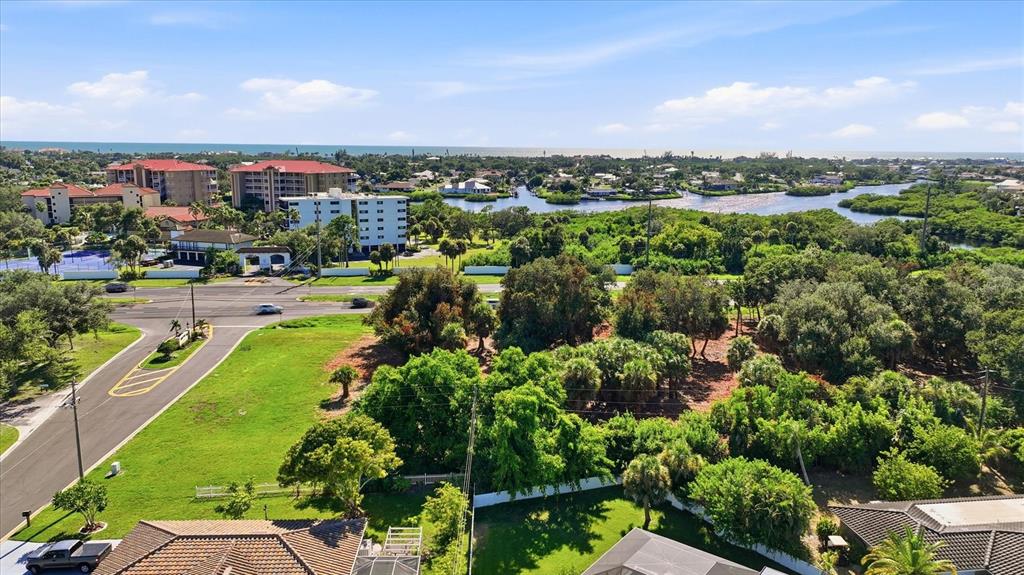 An aerial view shows a vacant lot situated between a residential street and a highway — 2099 S TAMIAMI TRAIL, OSPREY, FL