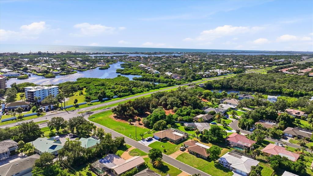 An aerial view shows a multi-lane highway bordering a residential neighborhood and a waterway — 2099 S TAMIAMI TRAIL, OSPREY, FL