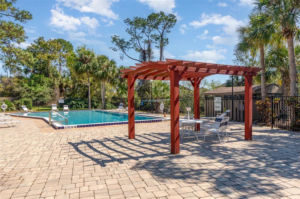 A dining room with a wooden table, six chairs, a sideboard, and a hanging light fixture — 4828 PEBBLE BEACH DRIVE UNIT A1108, ORLANDO, FL