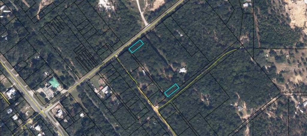 This aerial map shows two highlighted rectangular land parcels situated between two streets — CR-214, KEYSTONE HEIGHTS, FL