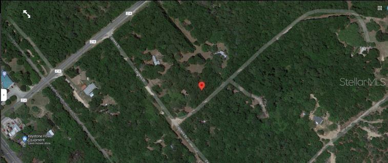 This aerial map view shows a wooded residential lot marked with a red location pin — CR-214, KEYSTONE HEIGHTS, FL