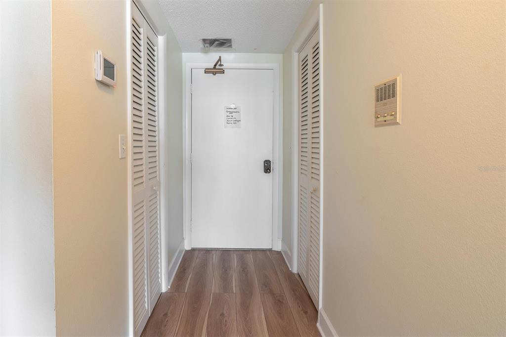 A balcony with a white railing overlooks a large body of water and palm trees — 100 PIERCE STREET UNIT 305, CLEARWATER, FL