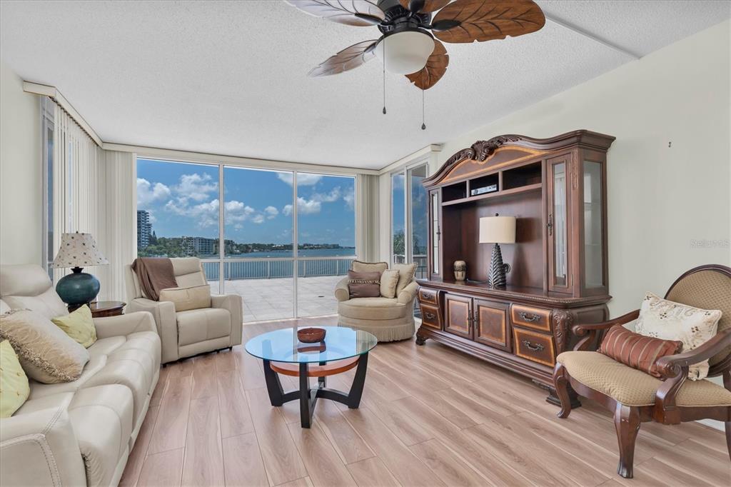 A balcony with a white railing, sliding glass doors, and a small table and chair — 100 PIERCE STREET UNIT 305, CLEARWATER, FL